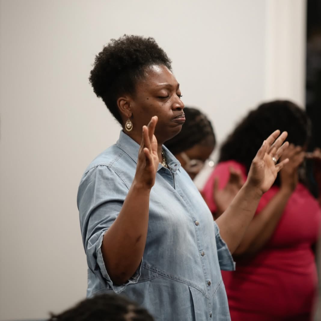 Woman in prayer during service