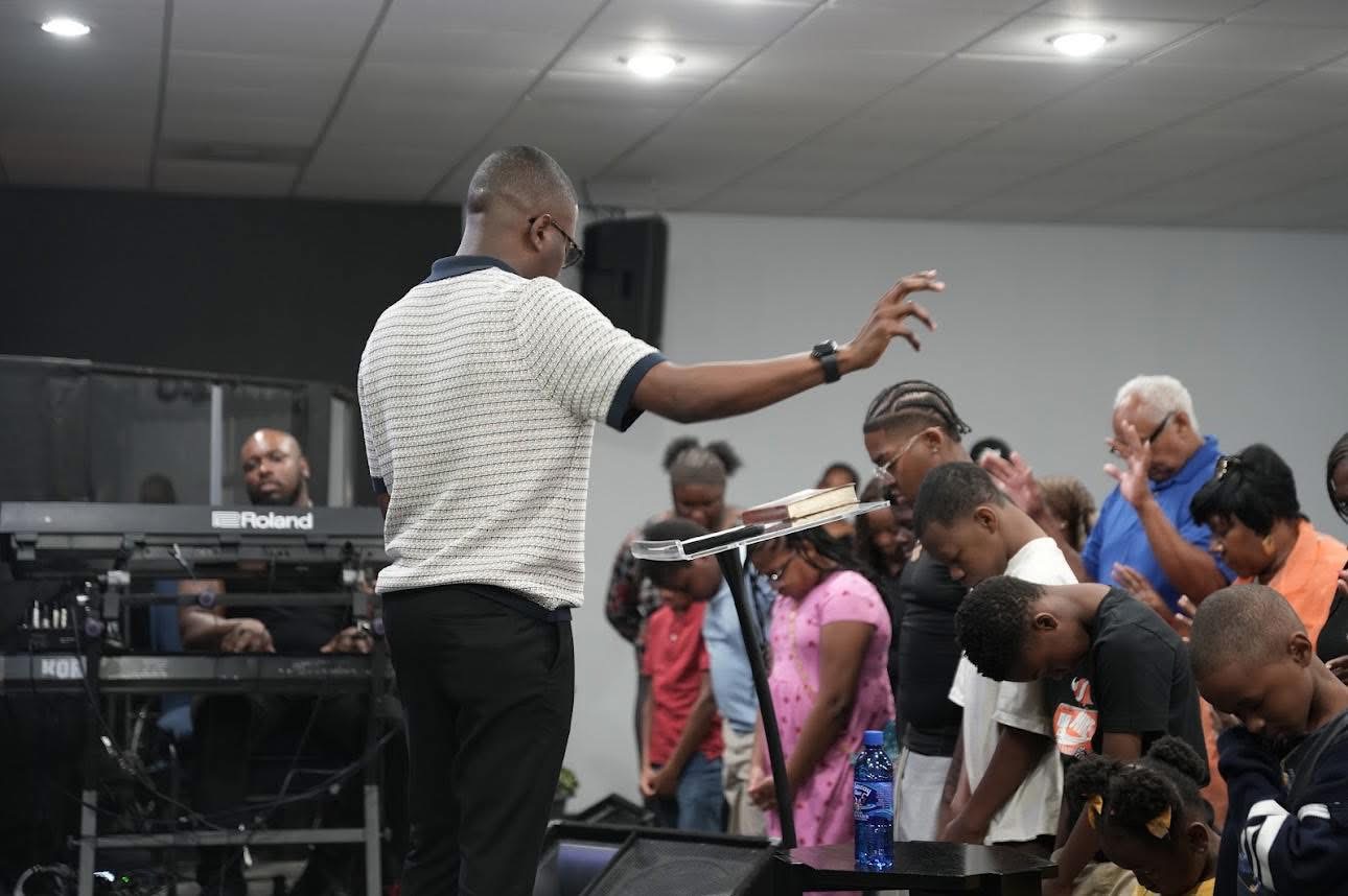 Pastor Marty praying over the congregation