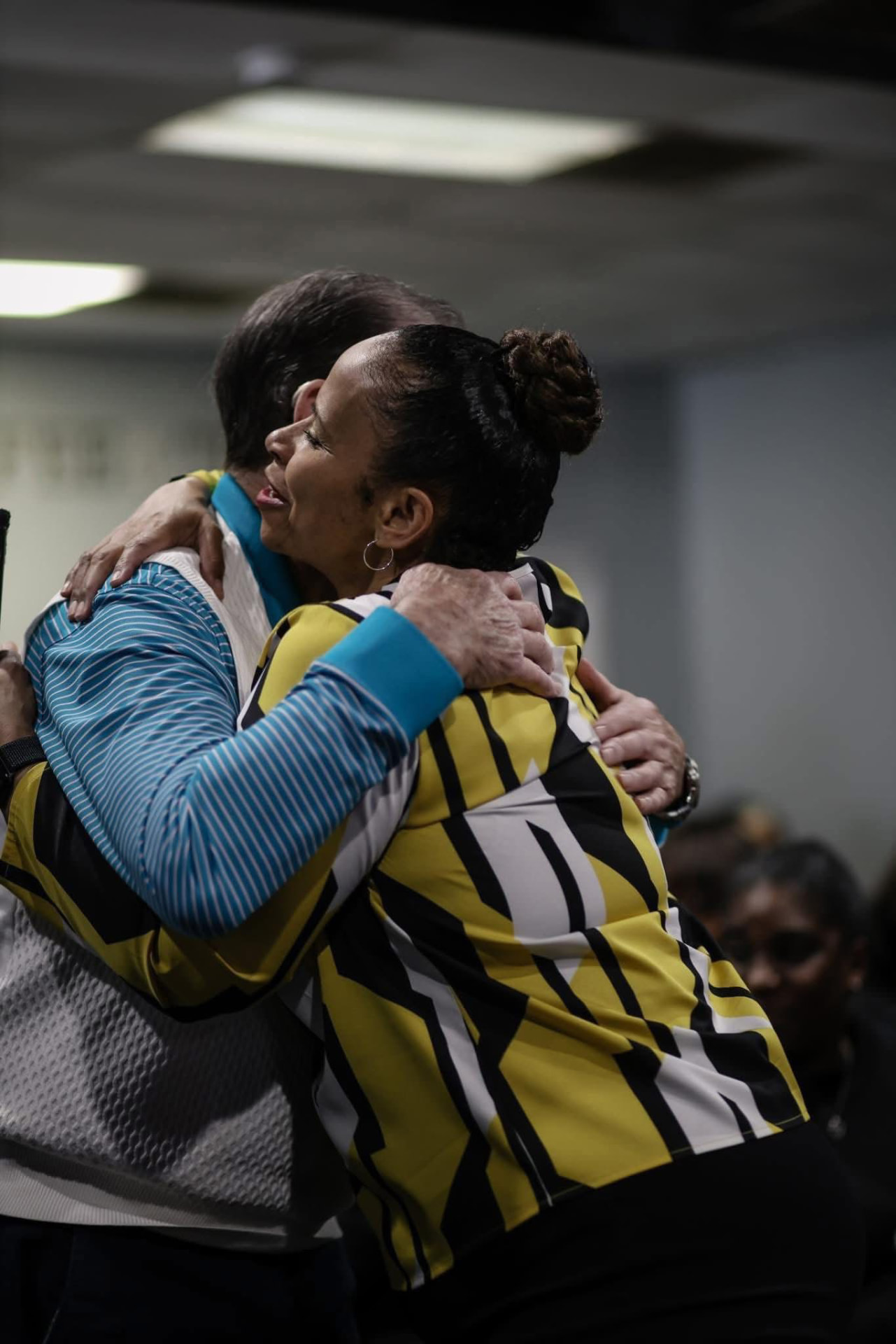 Two members embracing after service