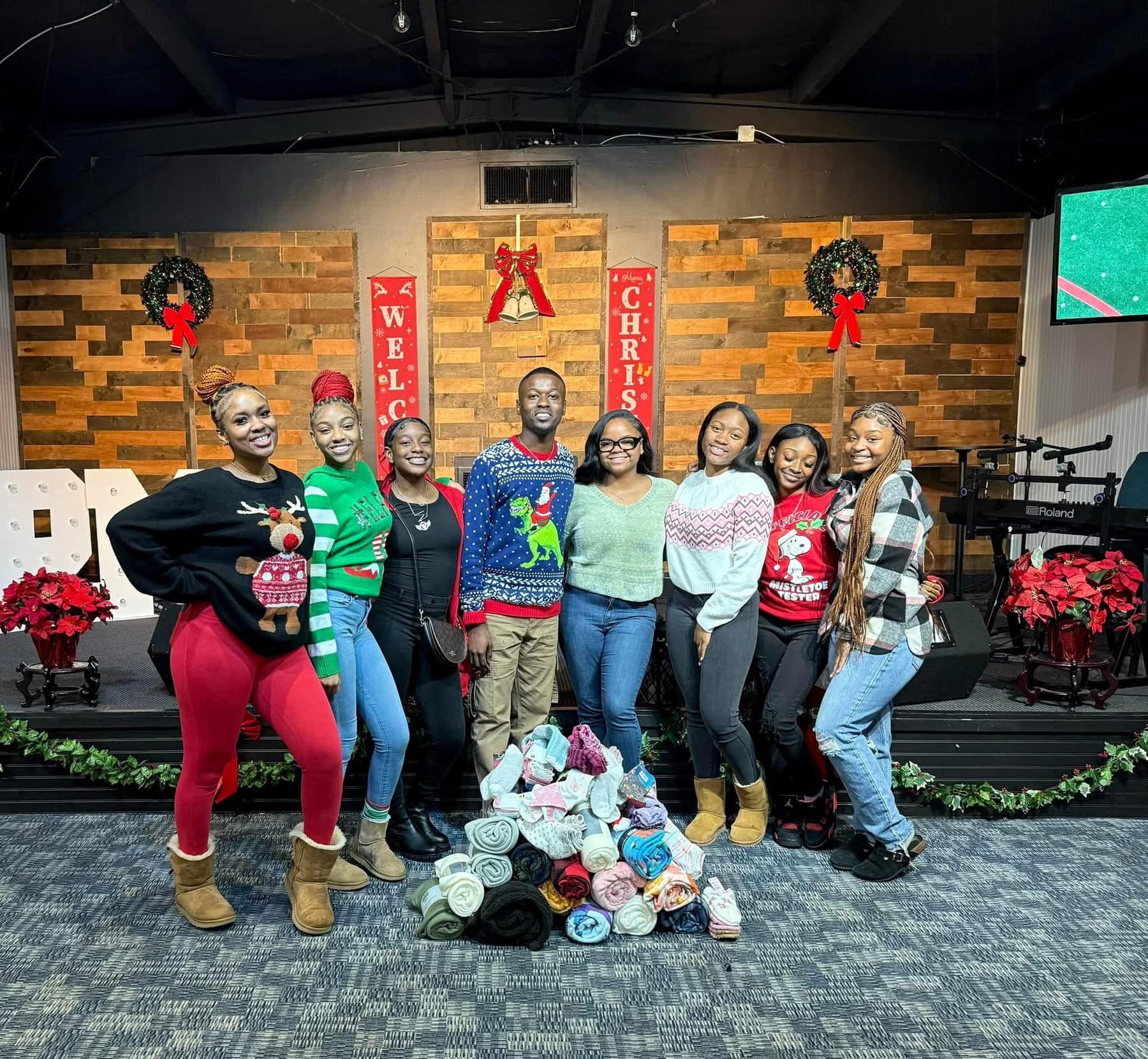 Team gathered with donated blankets at the Christmas outreach