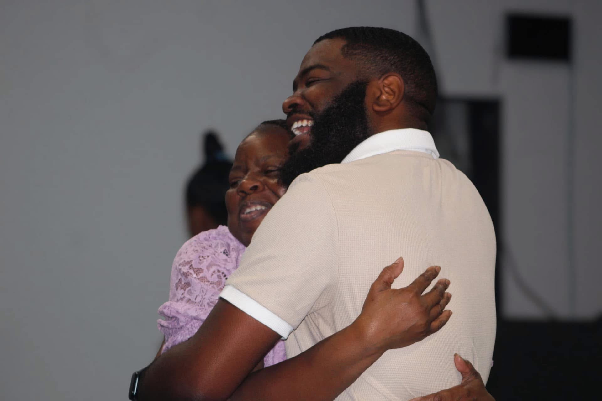 Pastor embracing a member after service