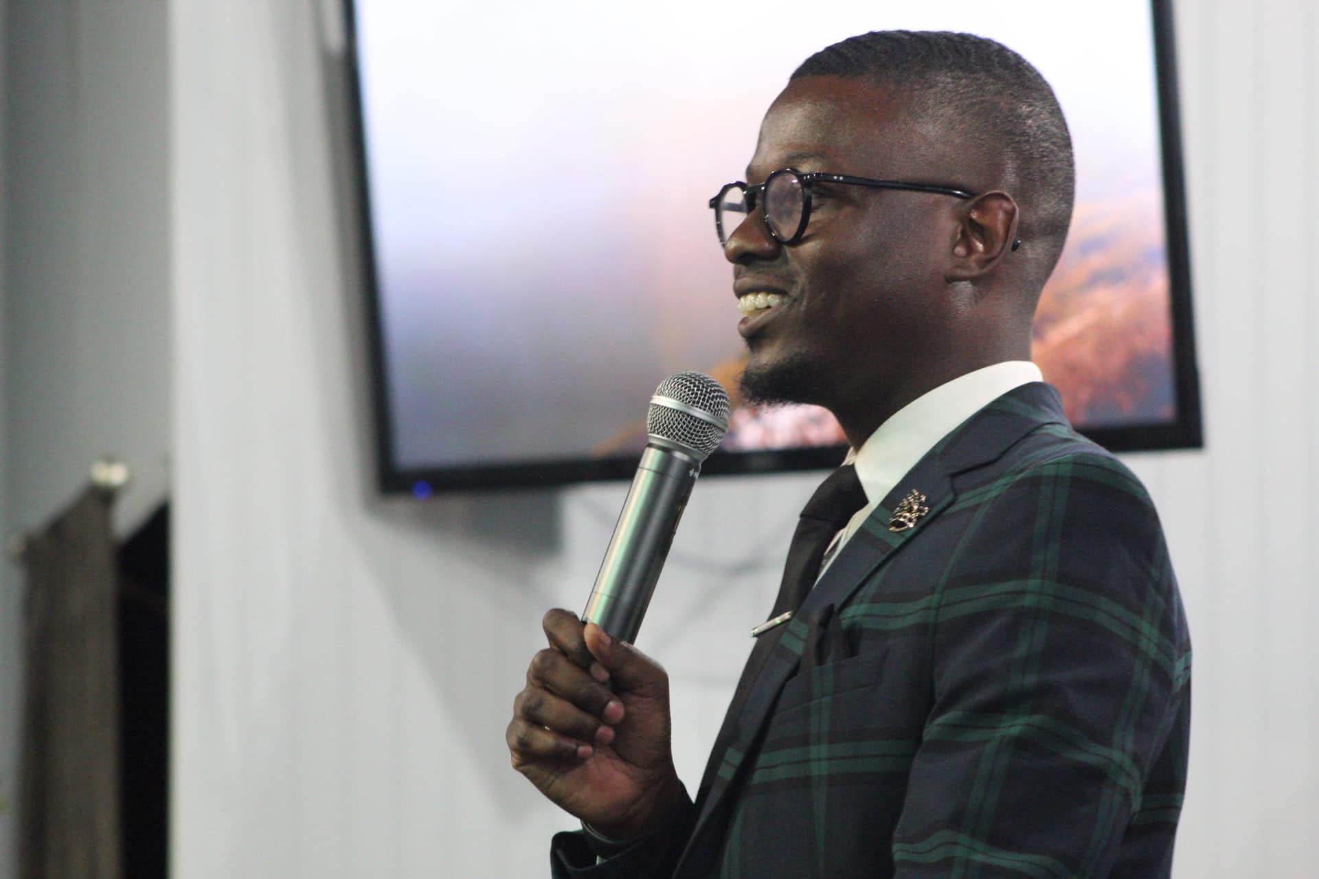 Guest speaker ministering with a microphone