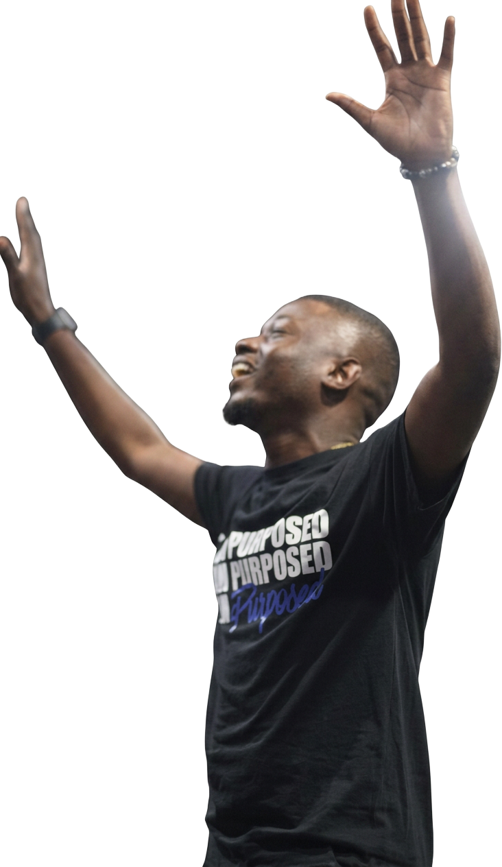 Man in a Purposed shirt worshipping with hands raised